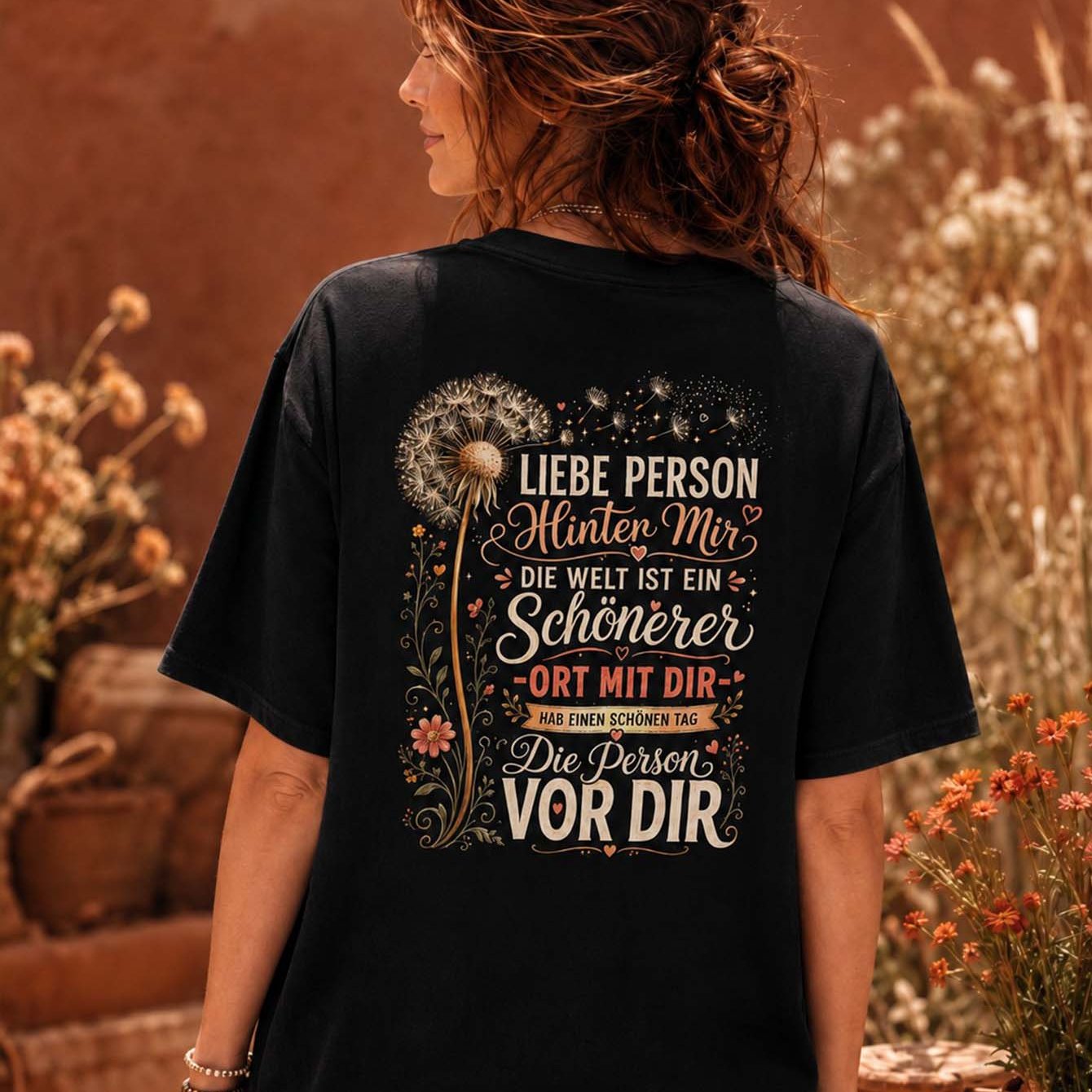 Image of Person Behind Me The World Is Dandelion Floral Back Print T-shirt Women Loose Fit Casual Short Sleeve Black Oversized Tee For Daily Wear